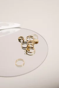 18K gold jewelry items on a glass tray