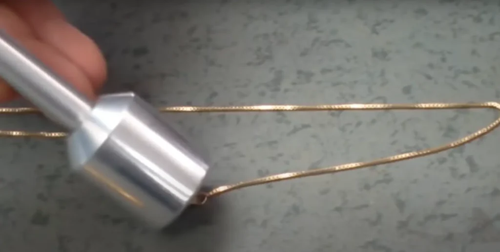 A demonstration of how to identify fake gold using magnets
